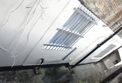 Ceiling with loose cabling around a light fitting