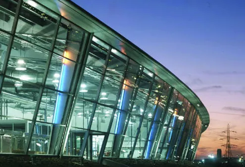 Modern glass-fronted office building at dusk